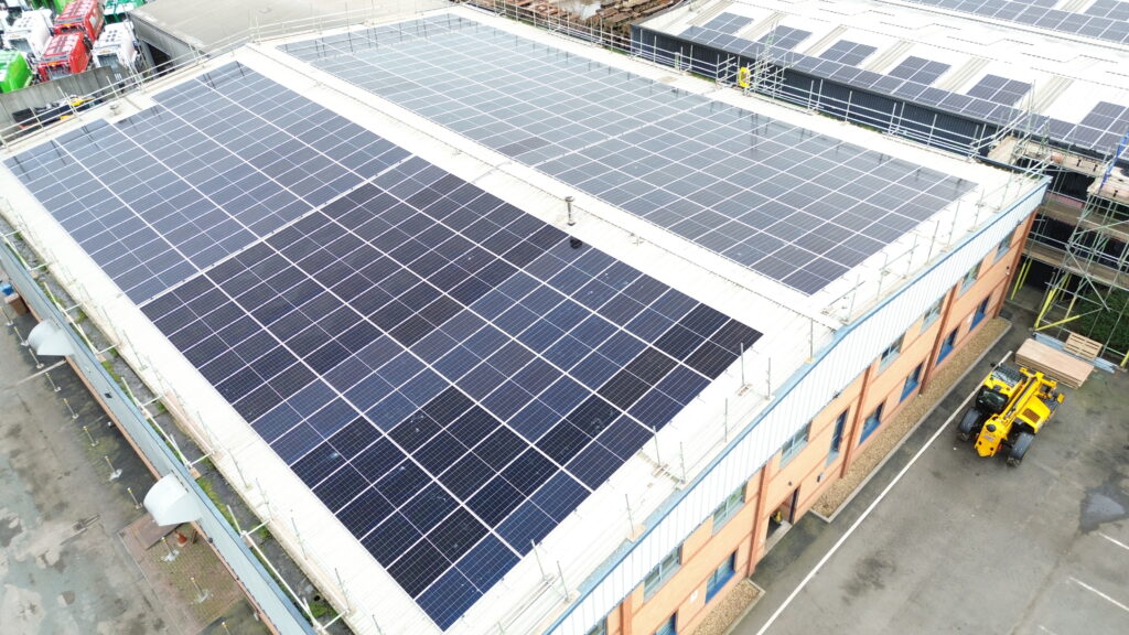 Large-scale solar panel installation on the roof of a warehouse